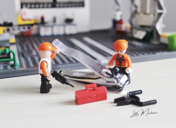 Image of little mechanics figuring out the mechanics of nail clipper